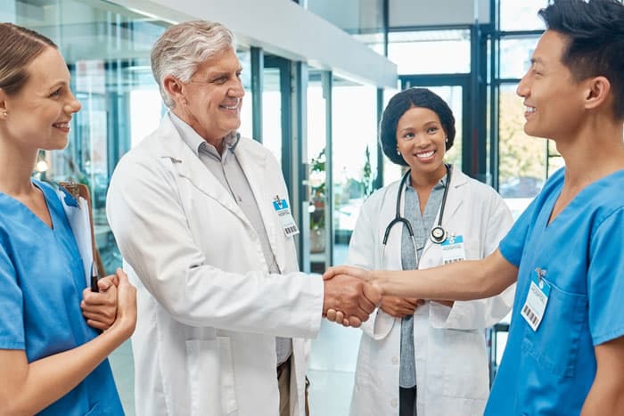 Shaking hands at the start of a first travel nurse job