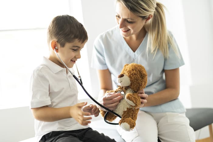 Pediatric RN job description includes nurse caring for young child