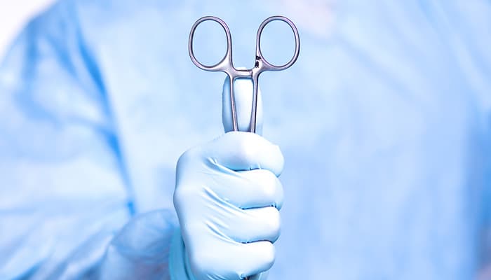 Certified Surgical Tech holding instrument