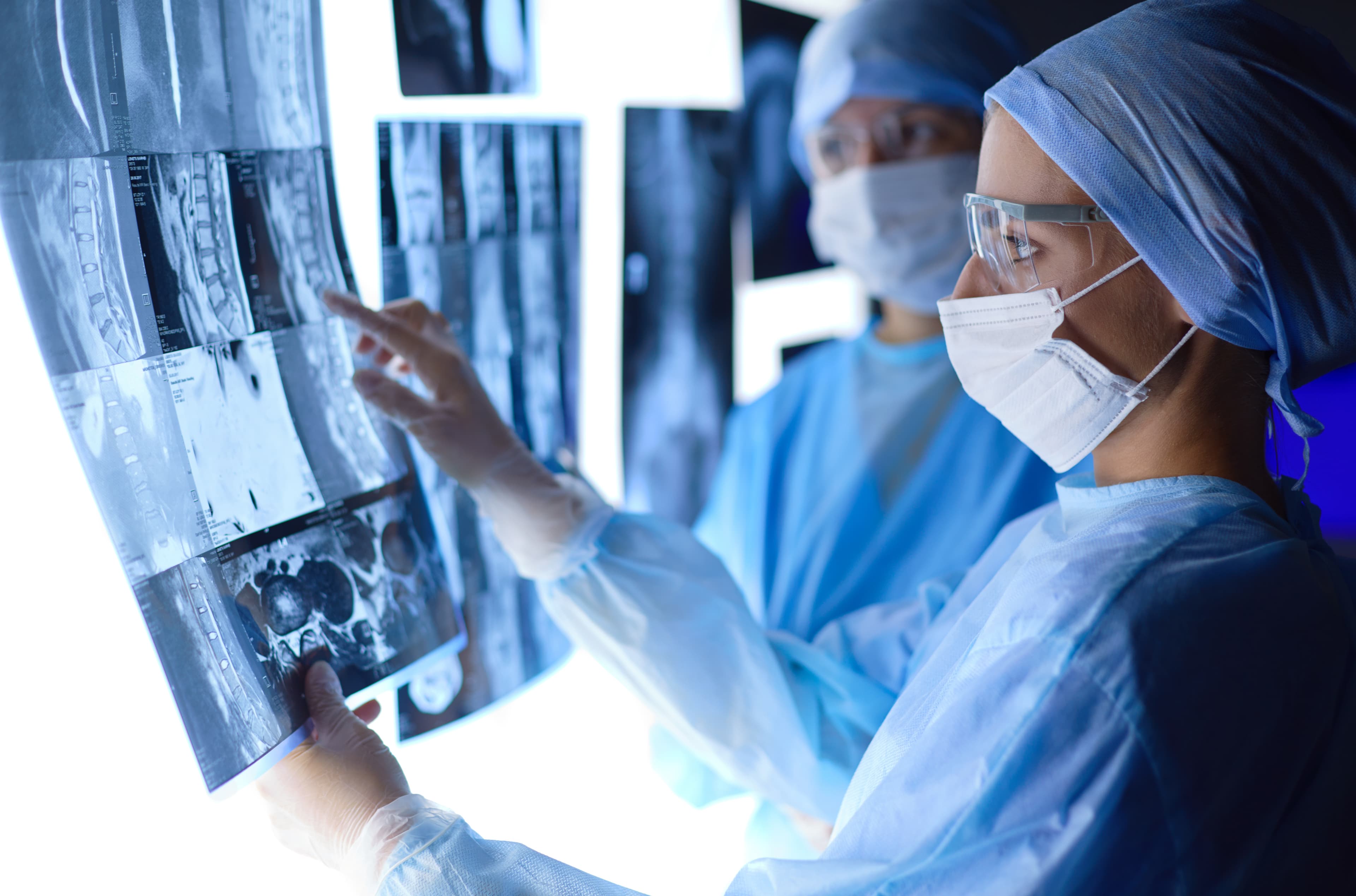 Interventional Radiology nurse examining x-ray images with colleague