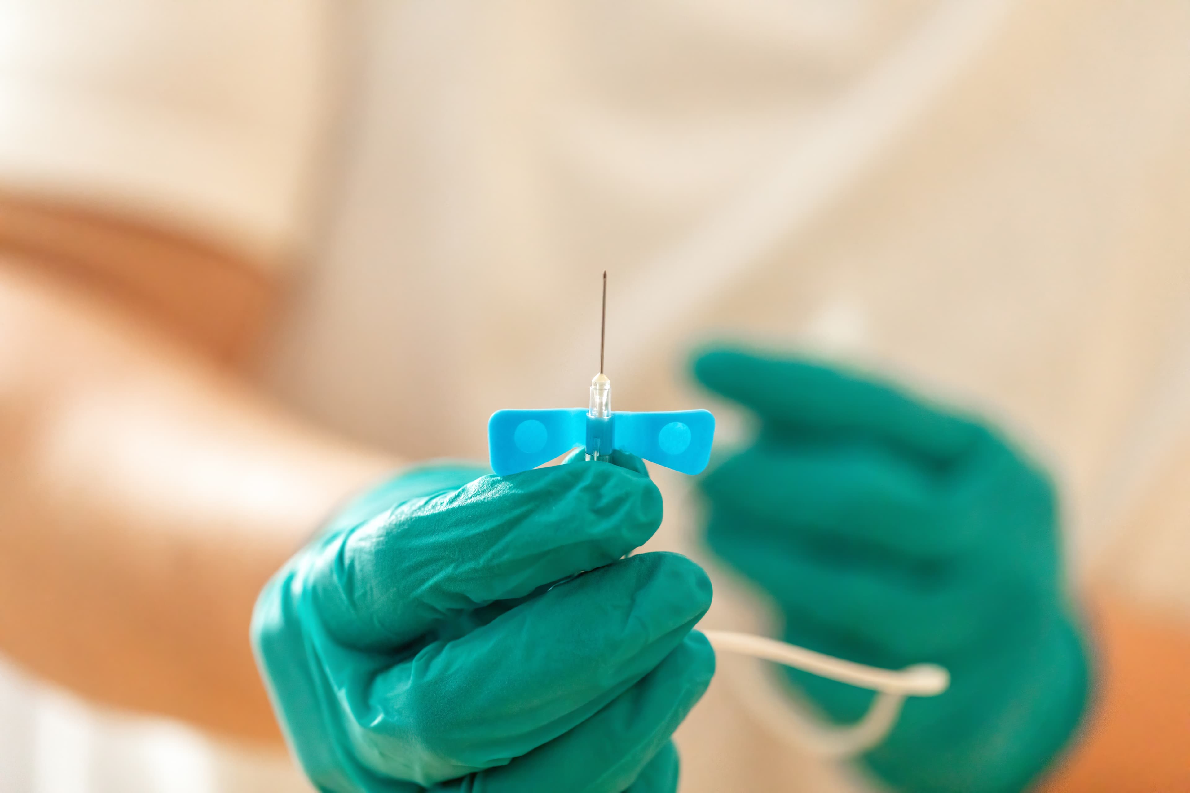 Close up of med surg nurse holding butterfly cannula