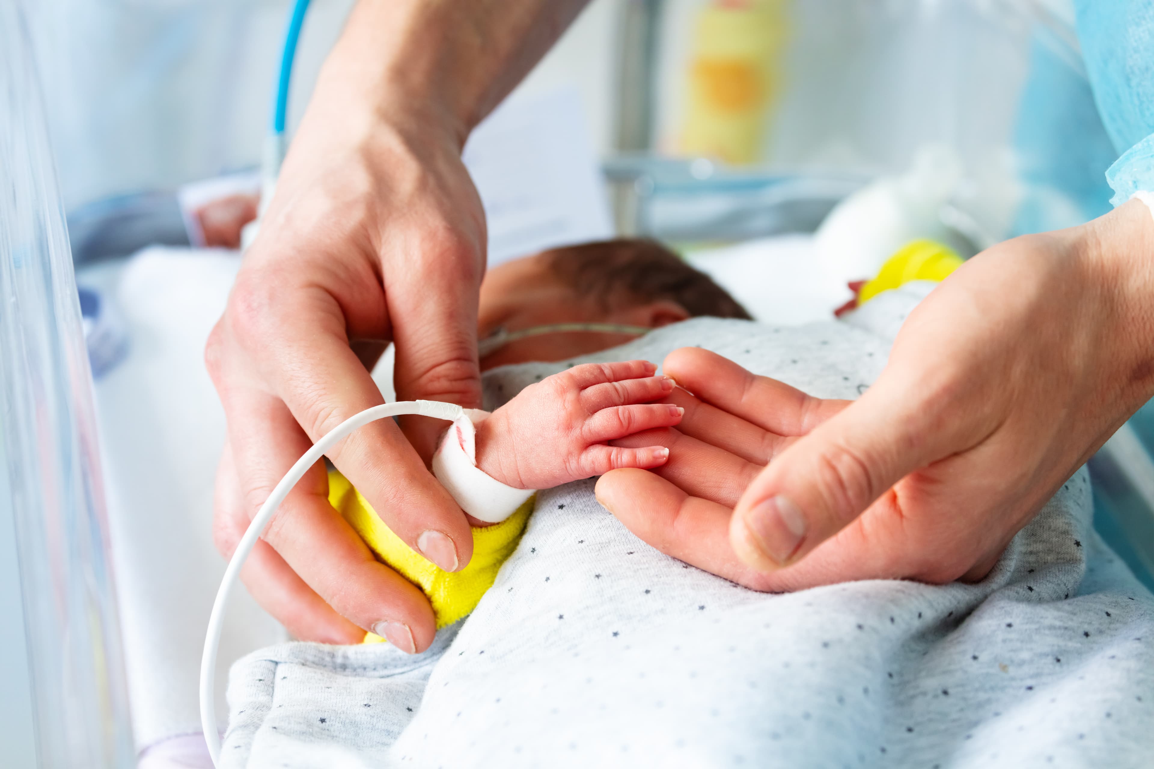 Neonatal ICU Nurse taking care of baby