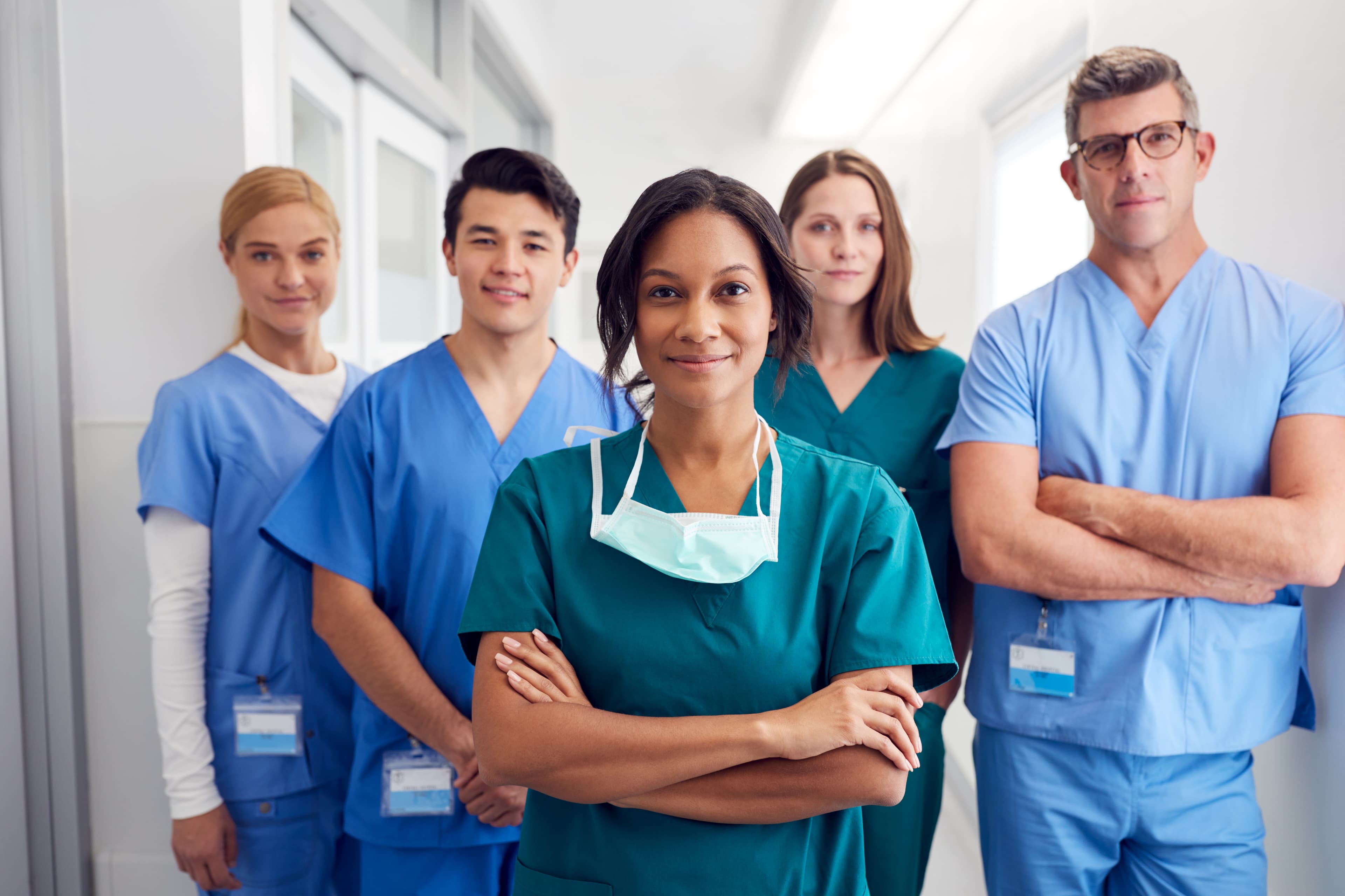 Nurse manager standing in front of team comprising four nurses