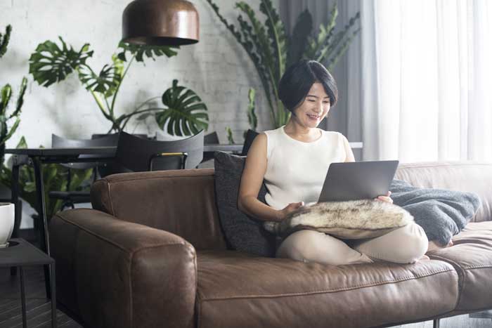 Woman with laptop finding work as a travel nurse partner