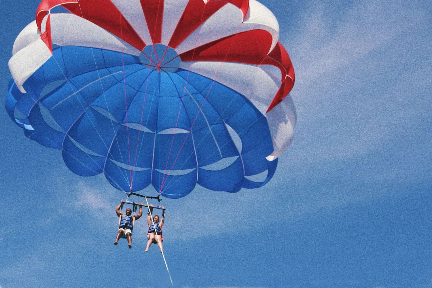 Adventurous travelers do parasailing
