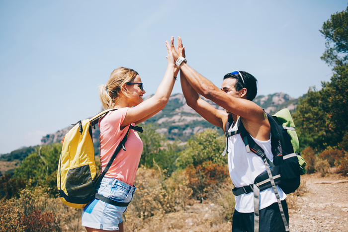 Two RNs high five to the advantages of travel nursing