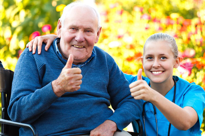 RN with elderly man, demonstrating patient advocacy in nursing