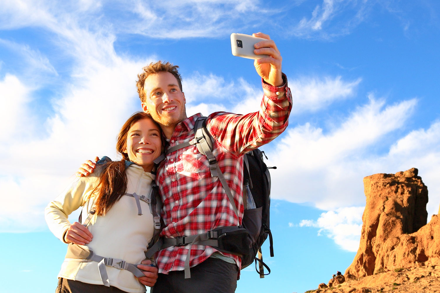 Two adventurous travelers taking a selfie out west