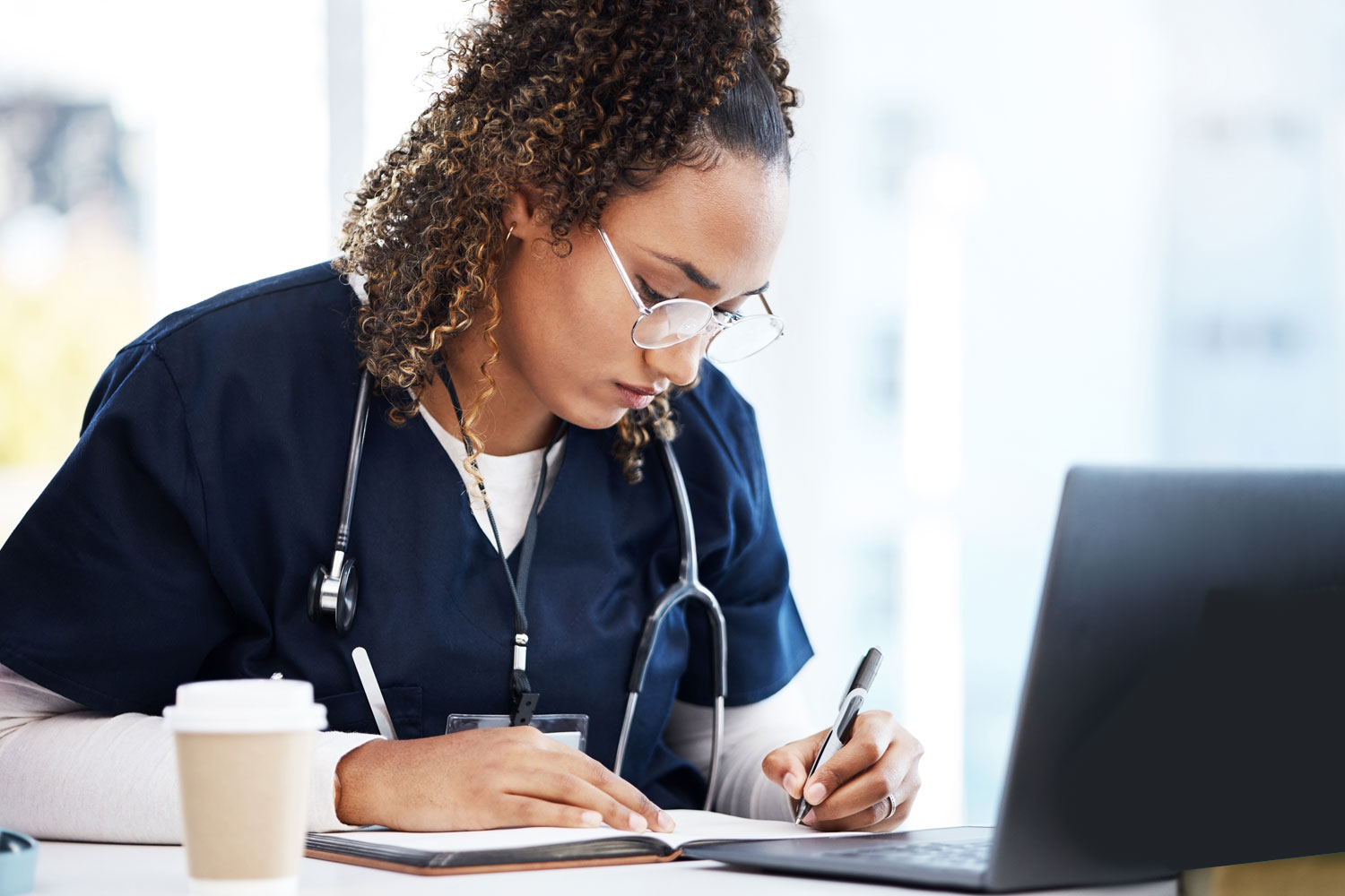 RN gathering information about travel nursing on laptop
