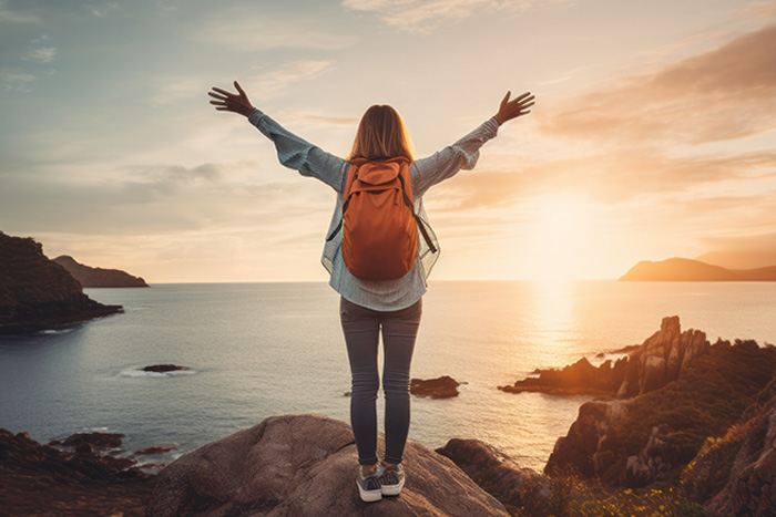 Woman at seaside celebrating travel nurse salary potential