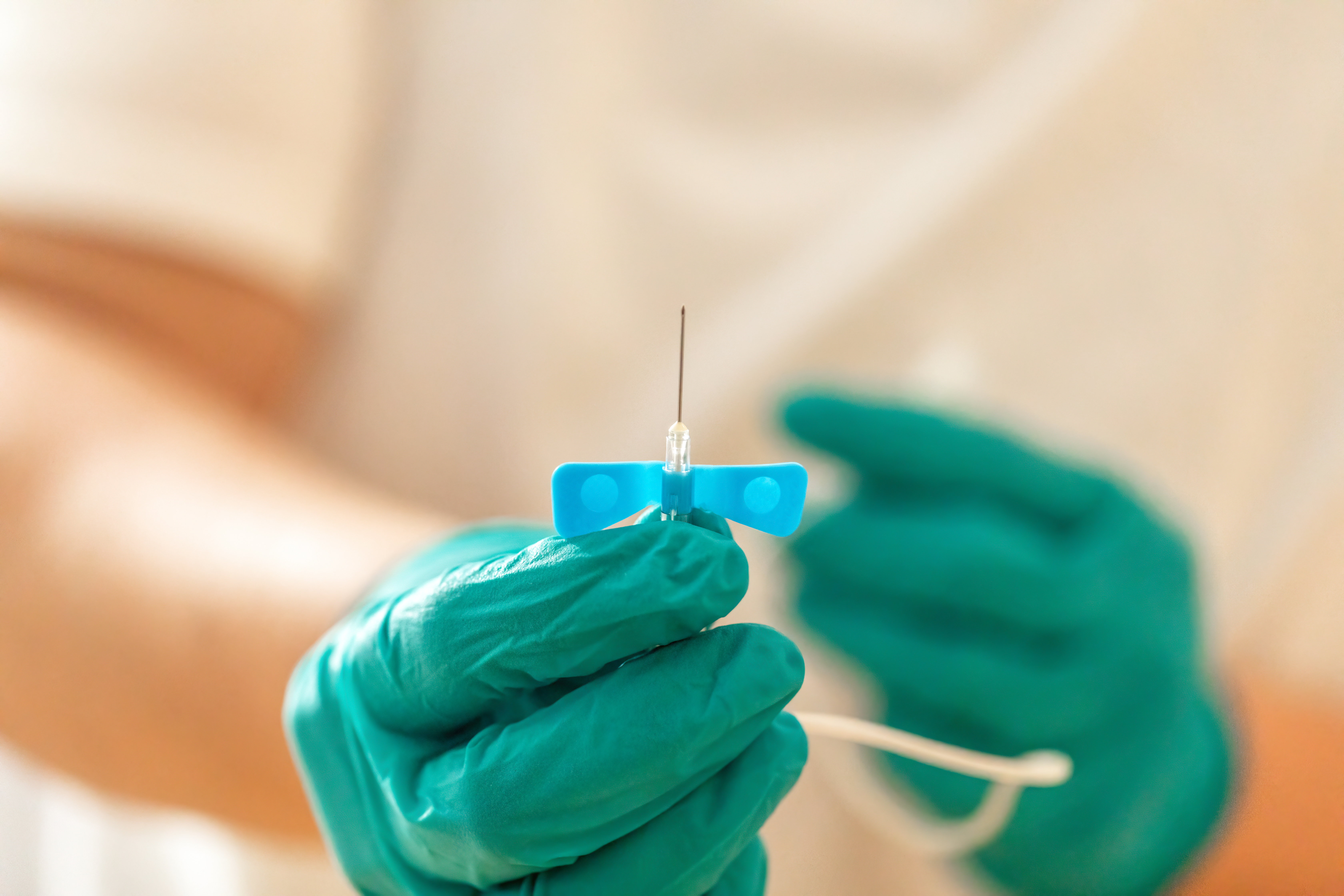 Close up of med surg nurse holding butterfly cannula